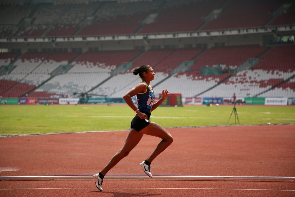 Female Athlete Sprinting on track during training session