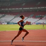 Female Athlete Sprinting on track during training session